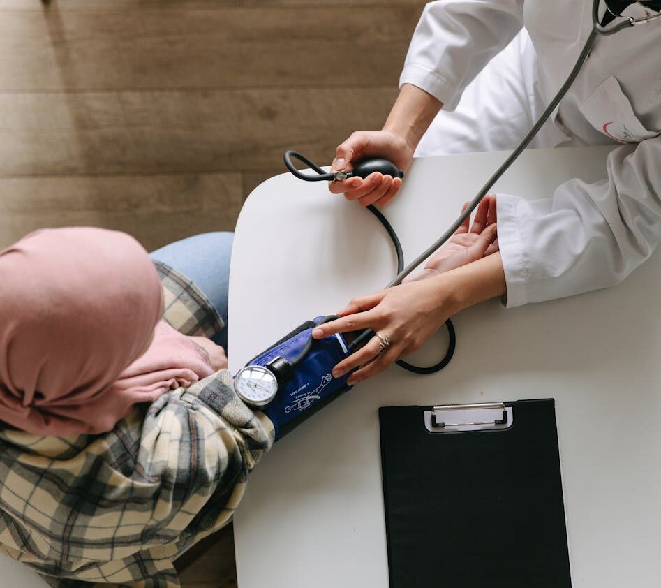 A Doctor Taking Patient's Blood Pressure